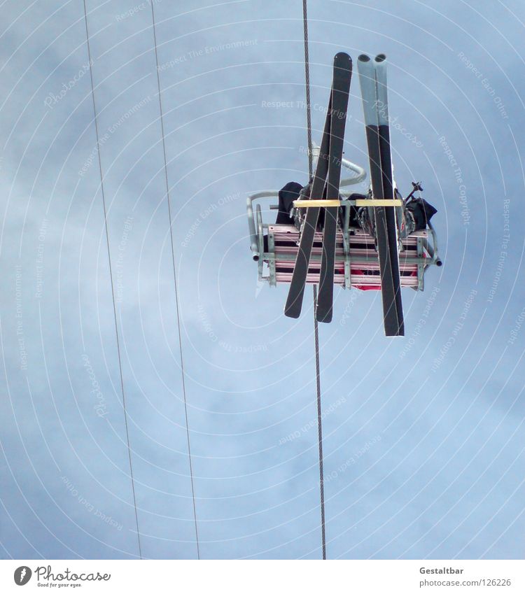 Up high! Ski lift Winter Skis Cold Sports Red Black Upward Mountain Sit Alps 4 Vallées In pairs 2 Side by side Worm's-eye view Above Tall Skier Chair lift