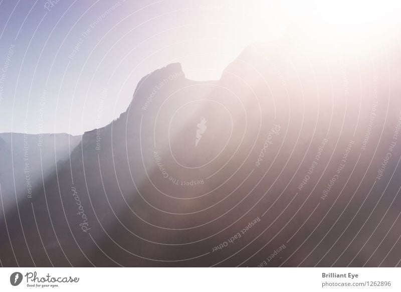 Sunlight over a mountain range Tourism Far-off places Summer Nature Sunrise Sunset Hill Rock Alps Mountain Esthetic Positive Yellow Optimism Power Might