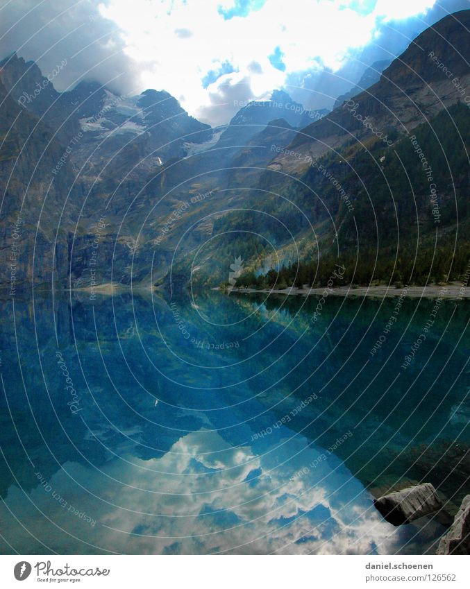 lake of mirrors Reflection Lake Switzerland Cyan Light Hiking Fir tree Green Summer Loneliness Calm Clouds Surface Sky Water Mountain Blue Sun Nature Alps Rock