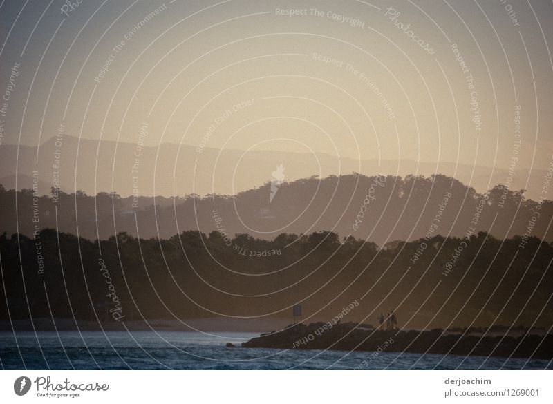 The evening mood on the coast is like a painting. Very soft colours and in the background blurred mountains and hills. Queensland / Australia. Exotic Calm