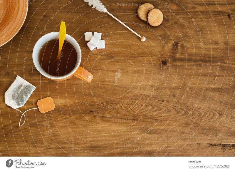 Tea- Time: a tea cup with tea bag, sugar and cookies on a wooden table Food Dough Baked goods Cake Dessert Candy Teabag Sugar Cookie Nutrition Organic produce