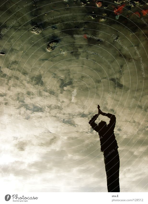 Ready to jump Fellow Posture Puddle Reflection Headfirst dive Jump Interlock Clouds Bad weather Silhouette Stone East Sky Water Human being personal photo