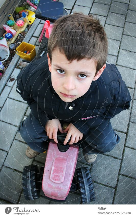 What are you looking at? Bird's-eye view Tractor Boy (child) Small Toys Grief Earnest Sweet Child sit Upward Perspective Sadness