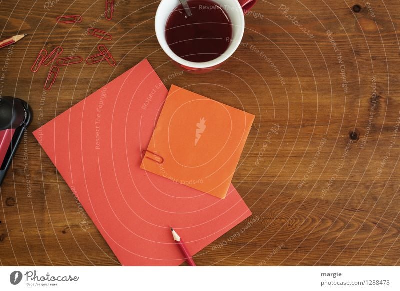 Red orange office: note with pencil, paper clips and a cup of red tea Hot drink Coffee Tea Cup Spoon Desk Table School Study Office work Business Stationery