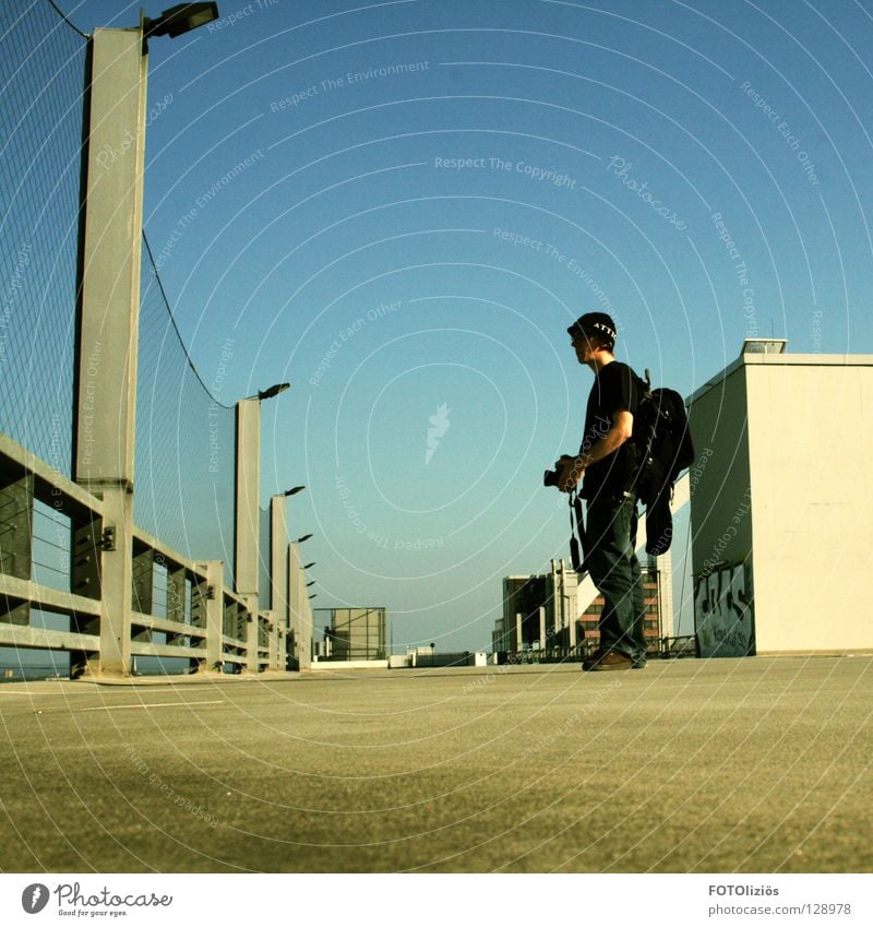 photo break Cologne Cap Photography Wall (building) Asphalt Lamp Backpack Paparazzo Cologne roof roof parking rooftop parking photographer Camera graffiti