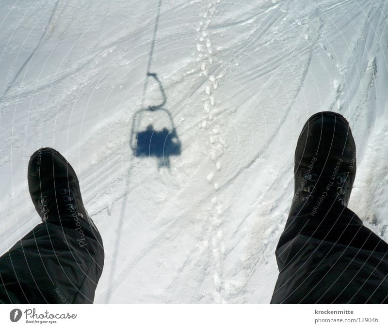 The dream of flying Footwear Ski lift Silhouette Chair lift Winter Winter vacation Winter sports Skiing Logistics Hiking boots Black White Hover Flying Snow