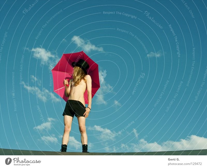 Pants down Young man Man Pink Top hat Black Shorts Border Thin Narrow Upper body Eroticism Innocent Sky blue Clouds Summery Long-haired Blonde Posture