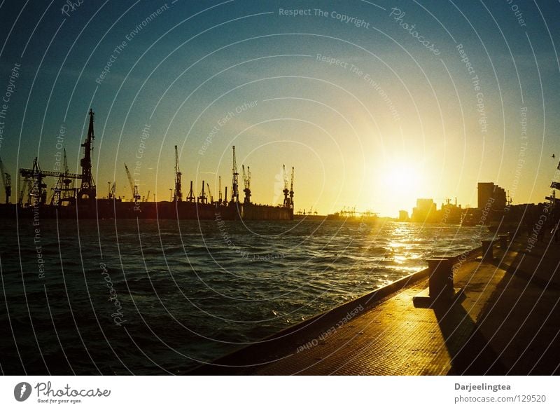 at the port Sunset Back-light Dock Crane Radiation Bollard Romance Vacation & Travel Harbour Hamburg Navigation Jetty Water Sky Evening Shipyard