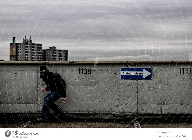 Welcome BLACKHEAD Man Fellow Black Dark One-way street Parking level Parking garage High-rise Dirty Digits and numbers Jacket Cold Winter Clouds