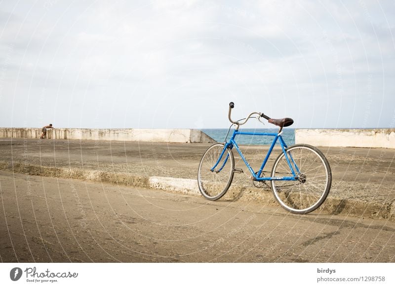 At the malecon of Baracoa / Cuba. A child looks longingly out to sea. In the foreground his bicycle Child 1 Human being 8 - 13 years Infancy coast Horizon