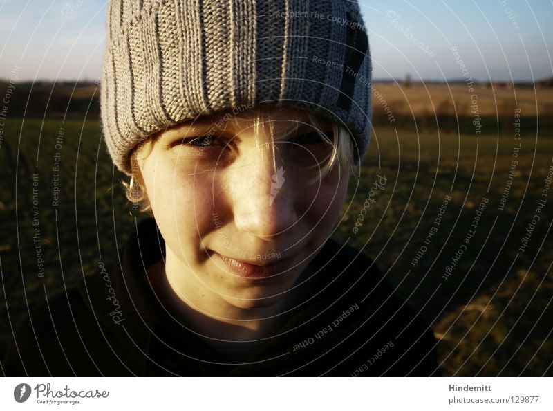 Spring under your hat, winter in your heart. Girl Beautiful Friendliness Sweet Dark Black Muddled Strand of hair Laugh lines Blonde Child Youth (Young adults)