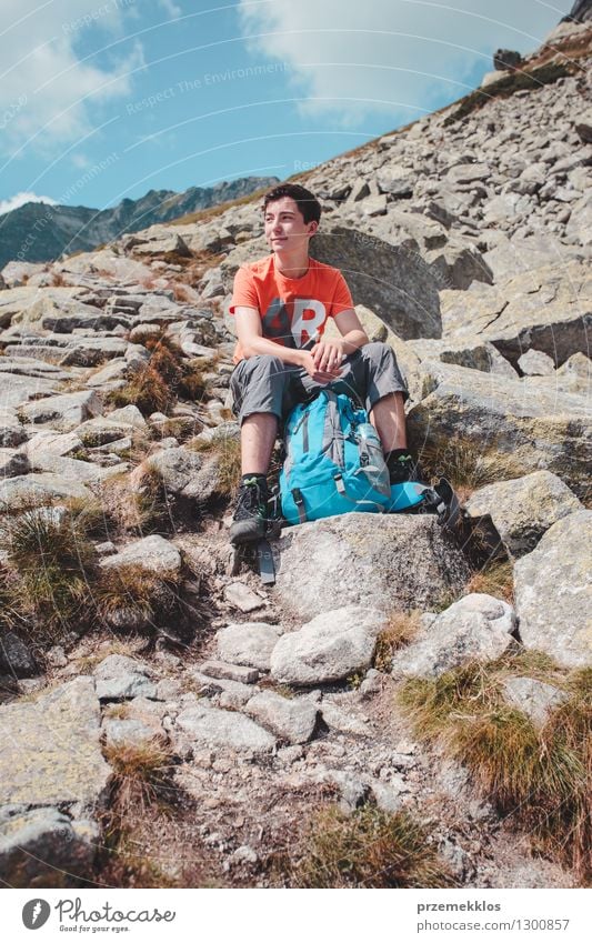 Boy resting on a rock in the mountains Lifestyle Vacation & Travel Trip Adventure Freedom Summer Mountain Hiking Boy (child) Young man Youth (Young adults) 1