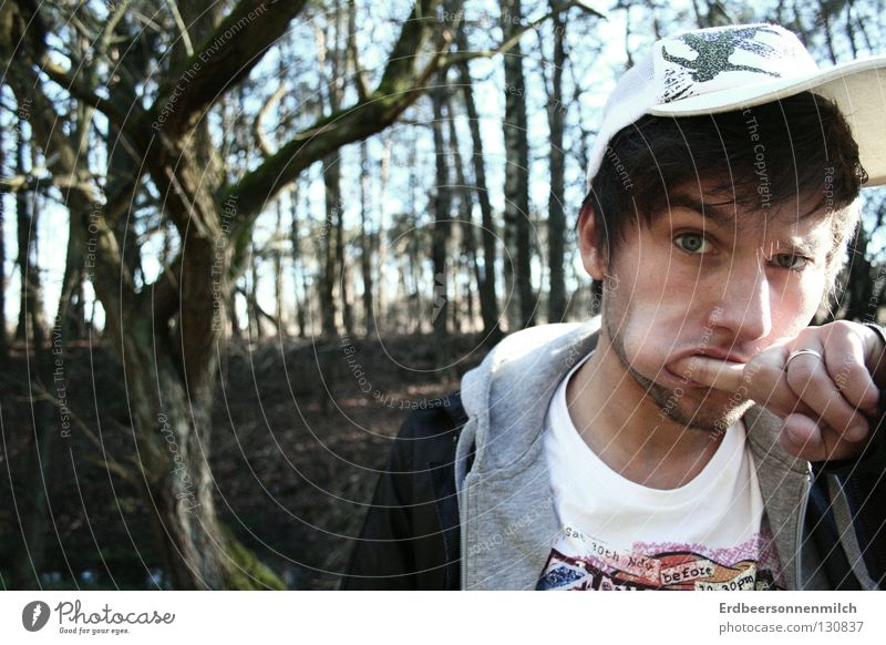 Boredom? Man Forest Cap Gesture Hooded sweater Hooded (clothing) Leather jacket Tree Beautiful Fantastic Joy Guy colorful t-shirt Fingers in the mouth Mouth