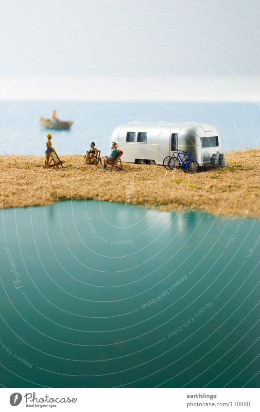 Small camper paradise Mobile home Caravan Miniature Green Deckchair Rowboat Reflection Close-up Far-off places Portrait format Digital photography Horizon Blur