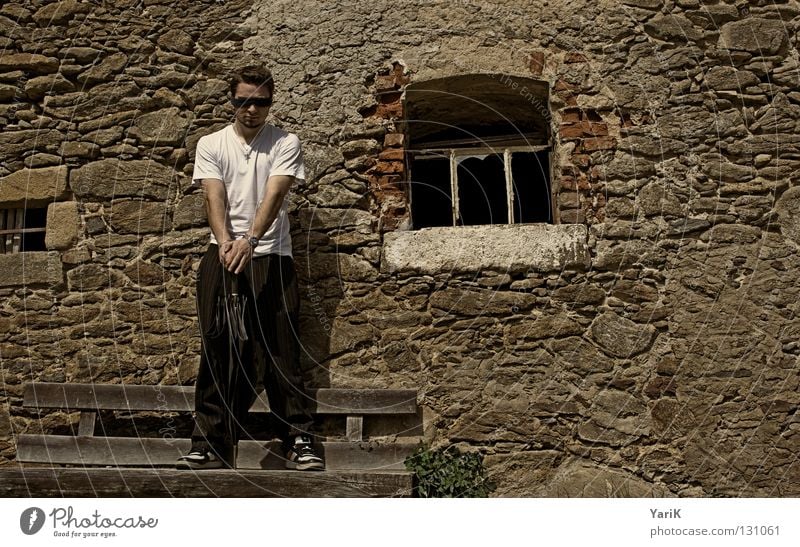 Waiting Umbrella Man T-shirt White Black Brown Stony Wall (building) Wall (barrier) Stone wall Plaster Drop shadow Happiness Cheerful Joie de vivre (Vitality)