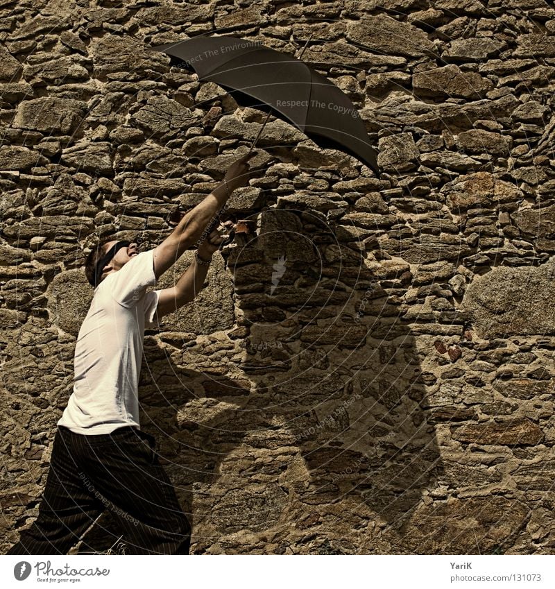 rockfall Umbrella Man T-shirt White Black Brown Stony Wall (building) Wall (barrier) Stone wall Plaster Drop shadow Happiness Cheerful Joie de vivre (Vitality)