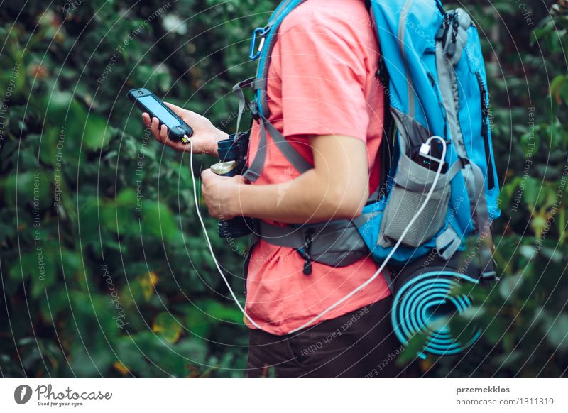 Charging mobile phone during the journey Vacation & Travel Trip Adventure Hiking Cellphone Cable Young man Youth (Young adults) 1 Human being 13 - 18 years