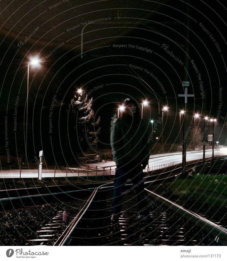 go your own way Man 16 Railroad tracks Long exposure Night Criminal Cool (slang) Lantern Street lighting Dark Rapper Style Cold Posture Dangerous Brave