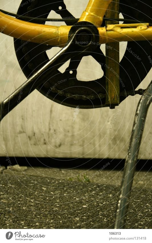 stand Pillar Bicycle Bicycle rack Stand Indifference Snapshot Life Yellow Concrete Asphalt Black Macro (Extreme close-up) Close-up Really Chain Gearwheel Street