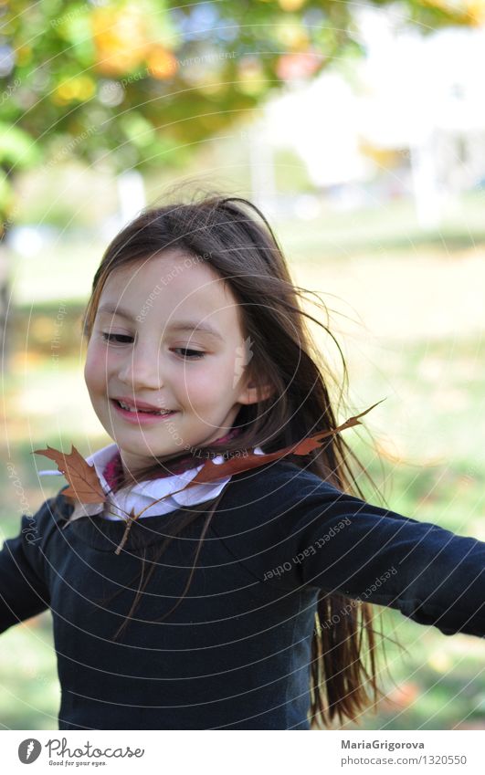 Dancing child and Autumn leaf Human being Feminine Girl Infancy Life Head Face 1 3 - 8 years Child Nature Sun Sunlight Climate Leaf Park Movement To enjoy