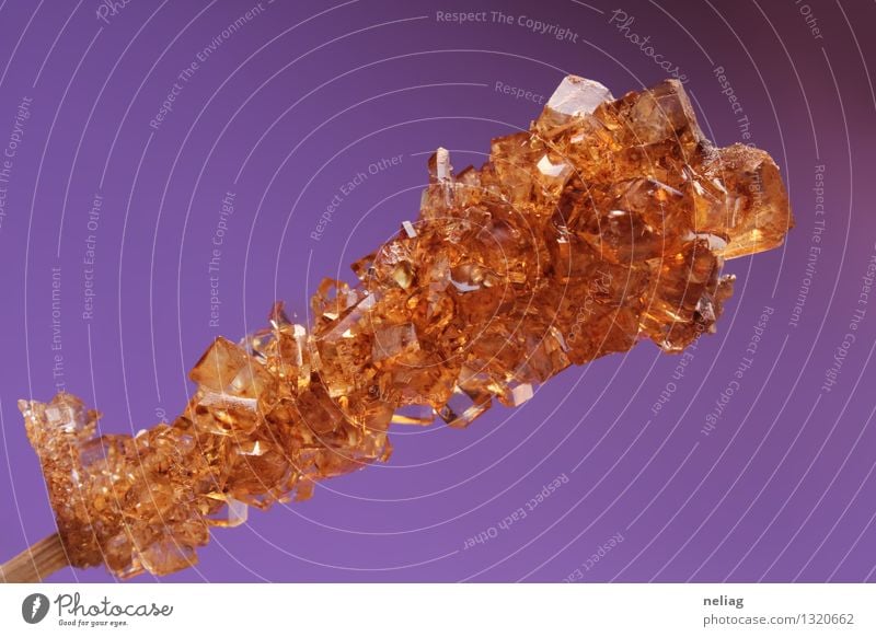 Brown sugar crystals on wooden stick on purple background Food Cake Dessert Candy Nutrition Breakfast Organic produce Diet Cold drink Hot drink Lemonade Juice