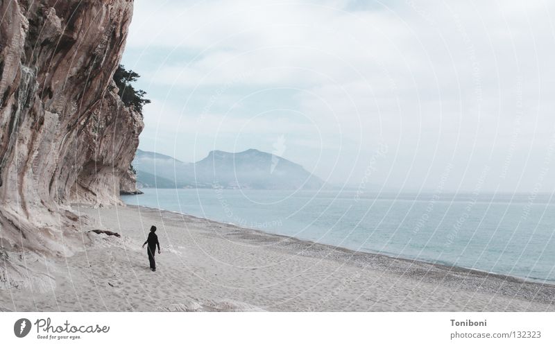 The Black Man and the Sea (and the Rock) Wall of rock Beach Ocean Clouds Loneliness Stagger Sardinia Italy Lime Small Vulnerable Sensitive Bad weather Fear