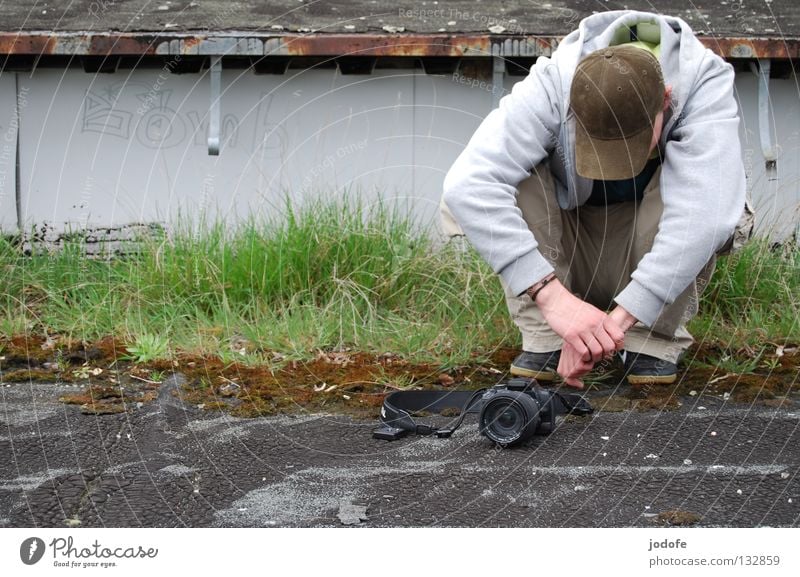 Bomb? Roof Grass Man Masculine Fellow Attract Sweater Pants Footwear Baseball cap Cap Take a photo Release Shoot Provoke Crouch Duck down Boredom Spring Green