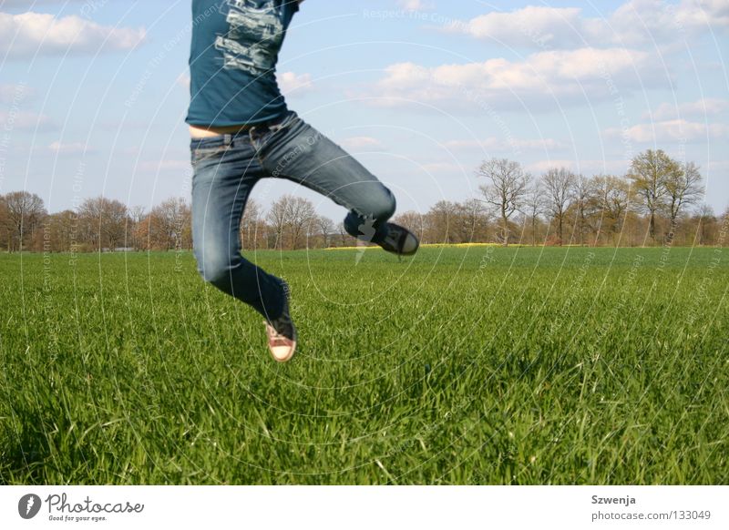 Jump into spring Colour photo Clouds Spring Field Blue Green Canola field jumping Partially visible forest