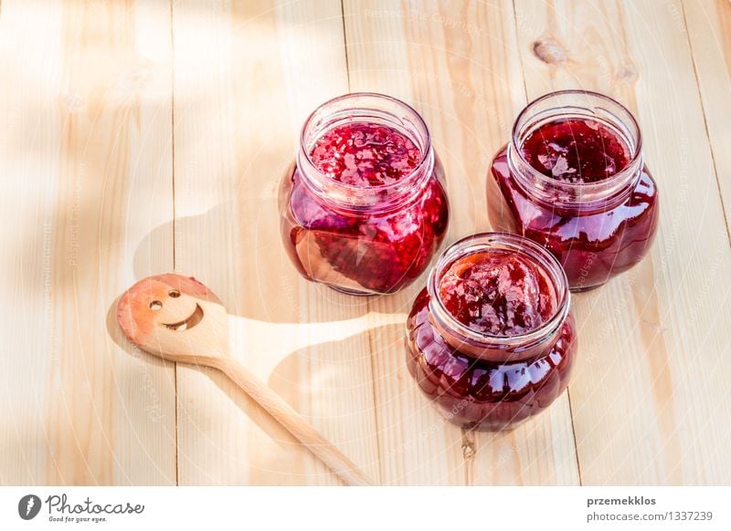 Homemade jam on wooden table Fruit Jam Nutrition Breakfast Organic produce Spoon Summer Table Nature Fresh Delicious Natural Red Tradition food glass healthy