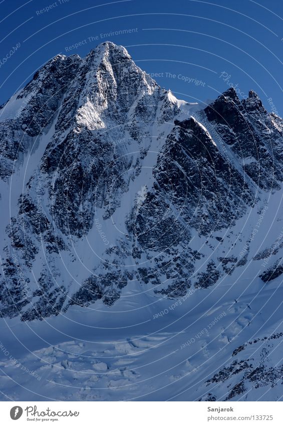 Großglockner Austria Grossglockner Peak Winter High mountain region Mountain Beautiful Snow Rock Blue sky Steep face Snowcapped peak