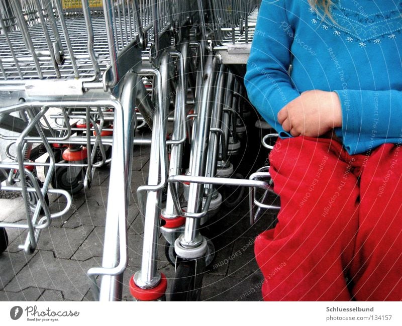 I want to go shopping! Toddler Shopping Trolley Pants Sweater Stone Dark Bright Blue Red Wheel Sit Girl Colour photo Multicoloured Exterior shot Day