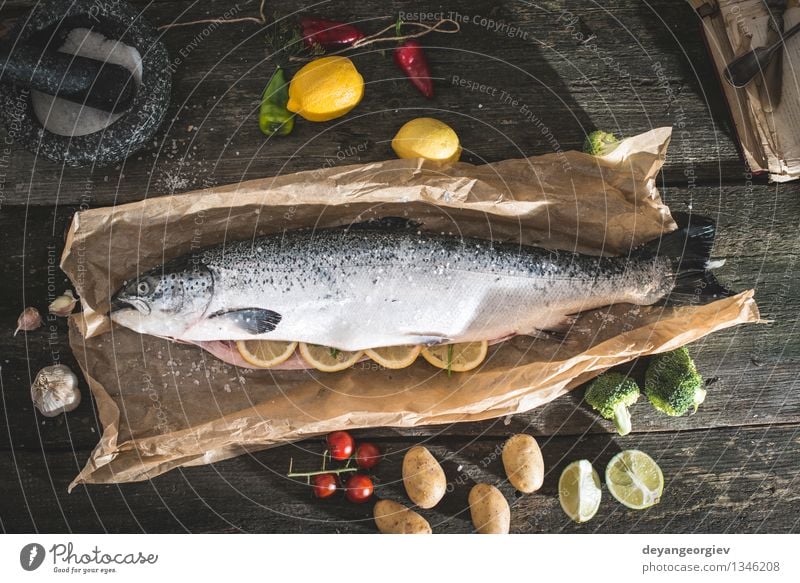 Preparing whole salmon fish for cooking Seafood Vegetable Dinner Table Rope Paper Dark Fresh Delicious Black Cooking Raw Ingredients Meal Lemon Preparation