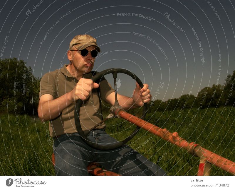 Carl, the tractor driver Farmer Male senior Man 45 - 60 years Adults Summer Grass Field Tractor Driving To hold on Sit Blue Green Red Sustainability