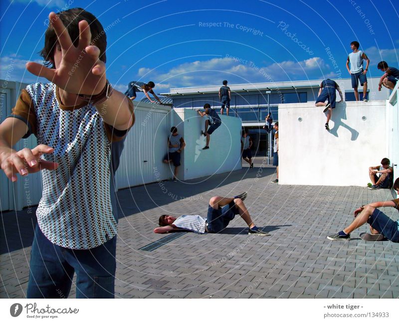 hanging around Relaxation Human being Hand Legs Sky Clouds Building Wall (barrier) Wall (building) T-shirt Jeans Hang Lie Sit Stand Blue Brown Gray White