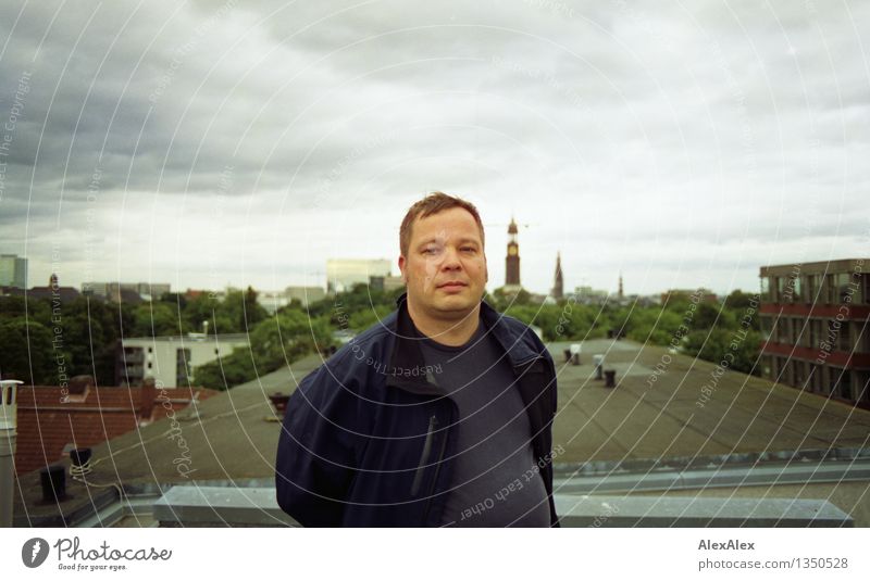 Young man standing on a roof in Hamburg Man Adults 30 - 45 years Clouds Skyline Town St. Michael's Church Roof Jacket Short-haired Observe Looking Esthetic Free