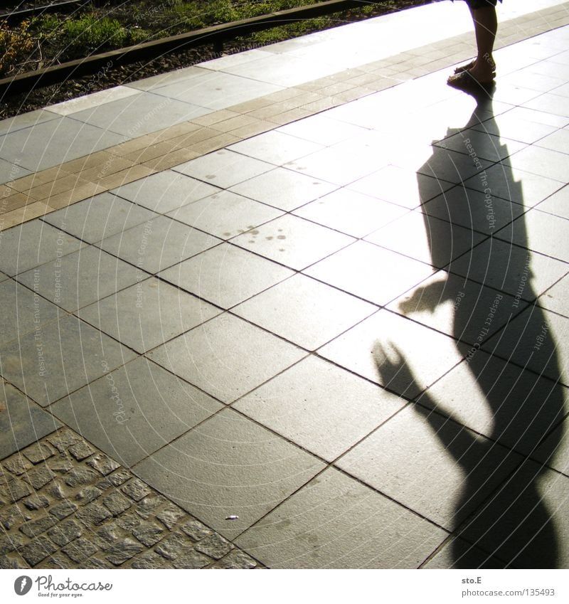 shadow figure Shadow Hand Posture Door handle Fingers Silhouette Dazzle Radiation Overexposure Diagonal Railroad tracks Places Traffic infrastructure Summer