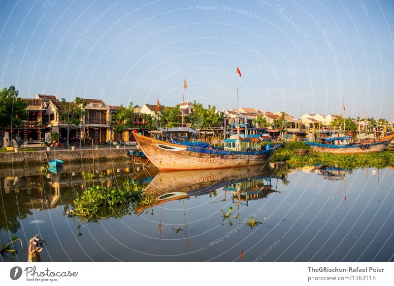 fishing village Environment Nature Landscape Water Blue Brown Yellow Gold Navigation Watercraft Fishing boat Ocean Town Coast Flag Sea water