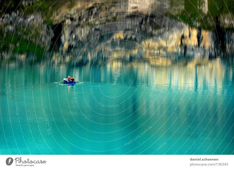 across the lake Reflection Lake Switzerland Green Cyan Fir tree Summer Loneliness Calm Clouds Surface Watercraft Fishing (Angle) Rowboat Bernese Oberland Colour