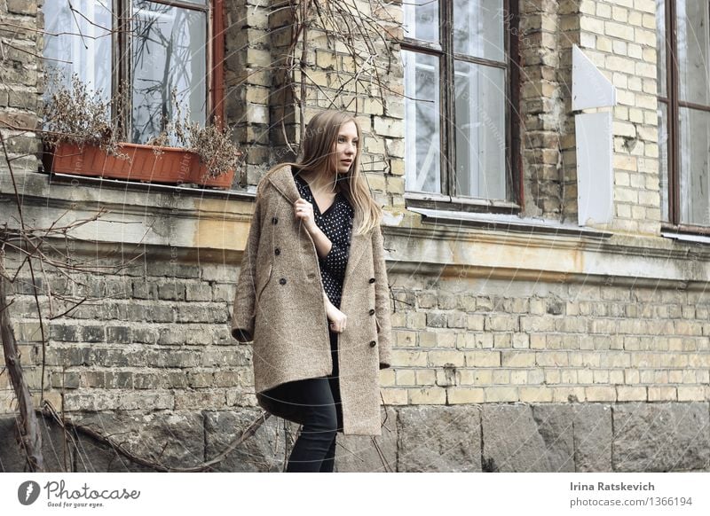 beautiful woman in coat looking away on the background of houses Young woman Youth (Young adults) Hair and hairstyles 1 Human being 18 - 30 years Adults Town