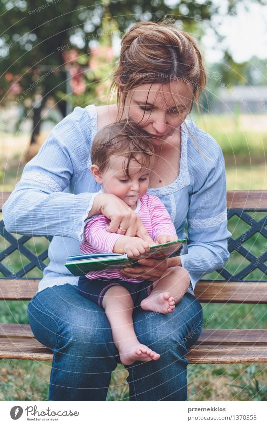 Mom reading a book her little daughter Lifestyle Joy Happy Beautiful Playing Reading Garden Child Baby Toddler Girl Woman Adults Parents Mother