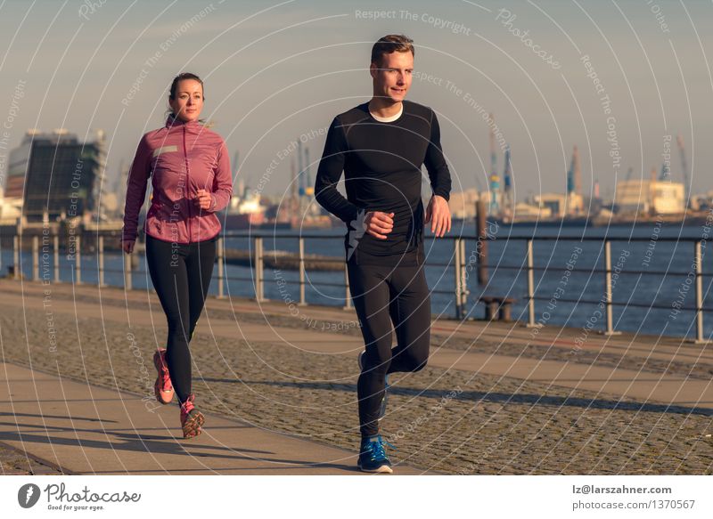 Young couple running on a seafront promenade Lifestyle Face Relaxation Sports Jogging Woman Adults Man Couple Partner 2 Human being 18 - 30 years