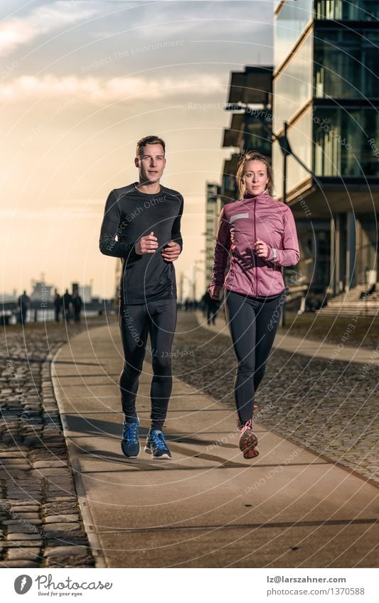 Active young couple jogging on a harbor promenade Lifestyle Face Sports Success Jogging Woman Adults Man Couple 2 Human being 18 - 30 years Youth (Young adults)