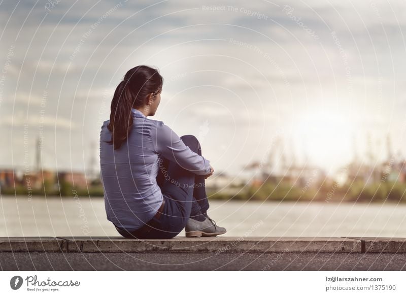 Thoughtful Woman Sits on Bench Facing at the River Lifestyle Relaxation Calm Summer Girl Adults River bank Town Harbour Jeans Brunette Long-haired Think