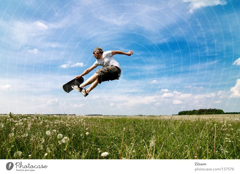 skate differently Jump Skateboarding Sports equipment Youth culture Action Grass Green Light blue Masculine Sky Summer Sunday Style Meadow Clouds Physics Juicy