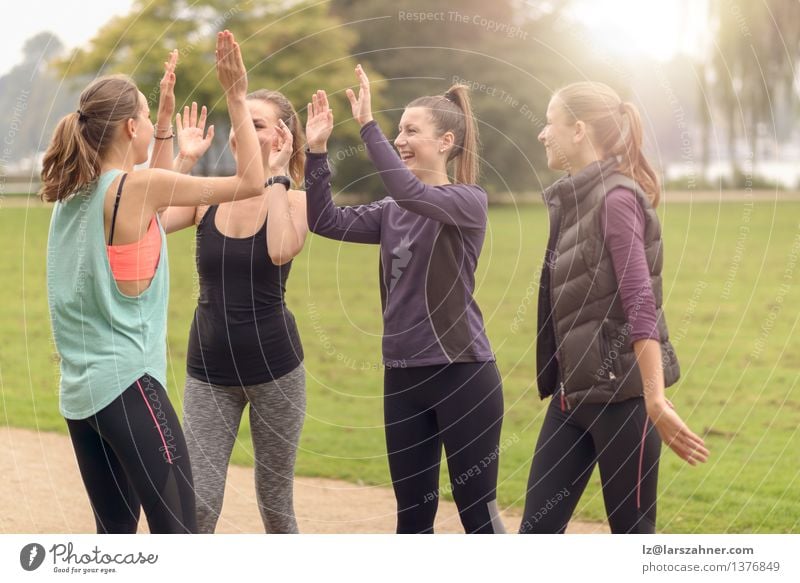 Happy Women Relaxing After Outdoor Exercise Lifestyle Feasts & Celebrations Sports Woman Adults Friendship Hand Group Park Lanes & trails Fitness Smiling