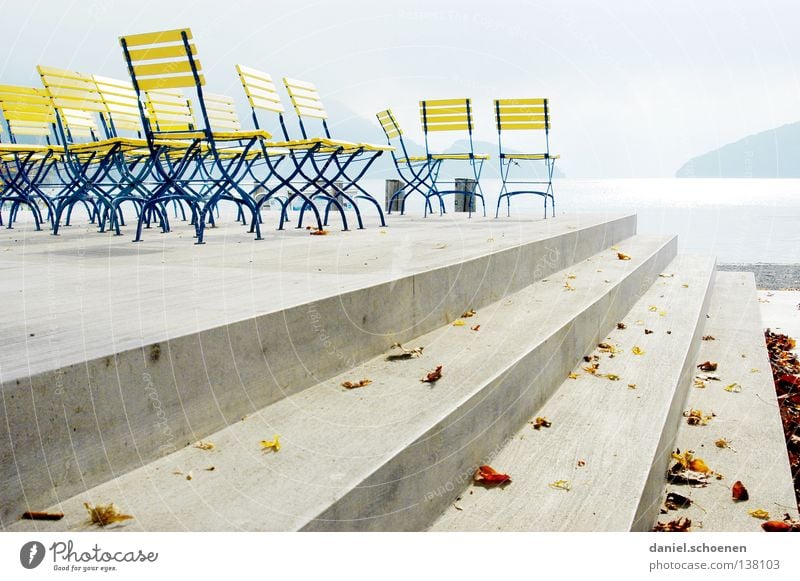 nothing going on Chair Lake Light Switzerland Lake Lucerne Holiday season Empty Calm Yellow Concrete Promenade Water Bright Blue Perspective Line Colour Coast