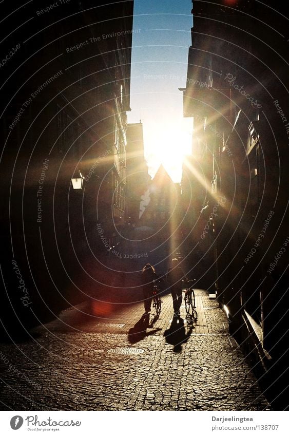 into the light Tübingen Town Back-light Radiation Sunset Marketplace Empty Friendship Bicycle Traffic infrastructure Celestial bodies and the universe Old town