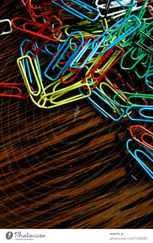 klammerkrams ll Paper clip Chaos Muddled Multicoloured Wood Yellow White Reddish black Green Flexible Wire Attachment paperclip chaos Wood grain