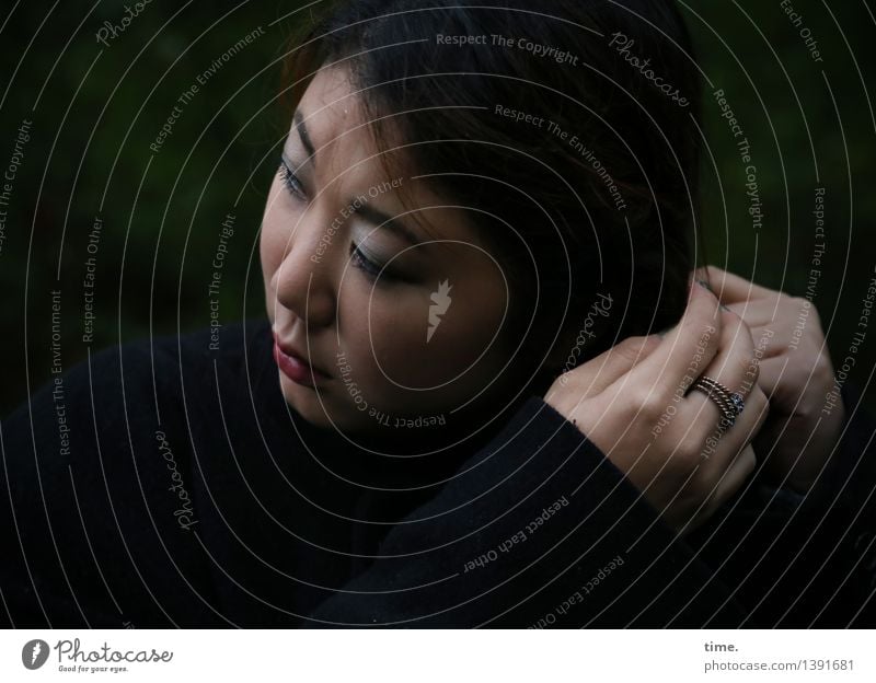 Woman in semi-darkness tying her braid Feminine Face Hand 1 Human being Ring Black-haired Long-haired Braids To hold on Esthetic pretty Watchfulness Serene