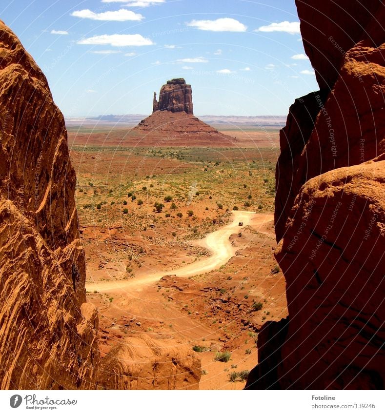 Landscape photograph of Monument Valley Clouds White Brown Plant Loneliness Americas USA mountain Mountain Lanes & trails Desert Stone Sky Blue Shadow Rock